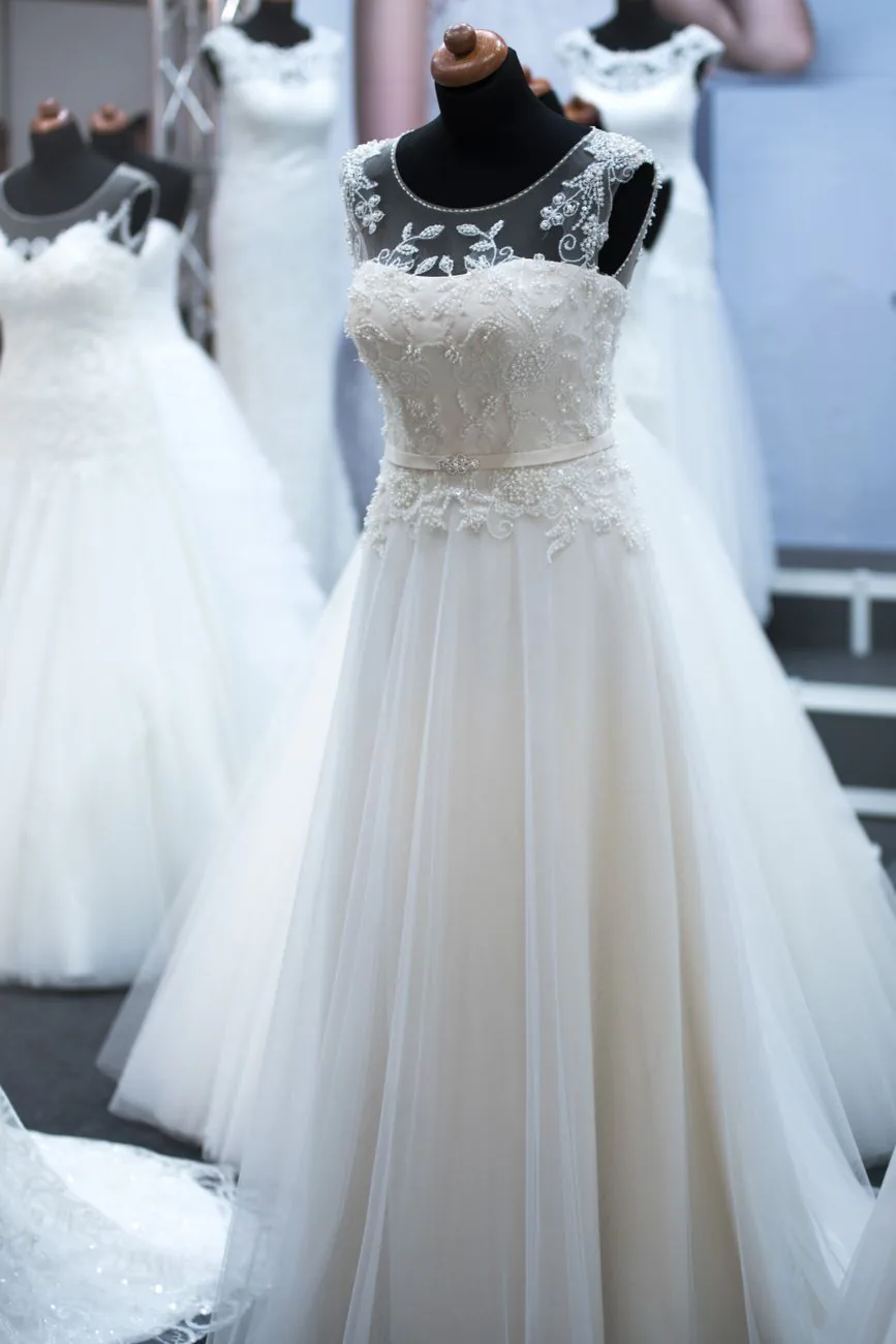 Elegant wedding dresses on mannequins at bridal showcase