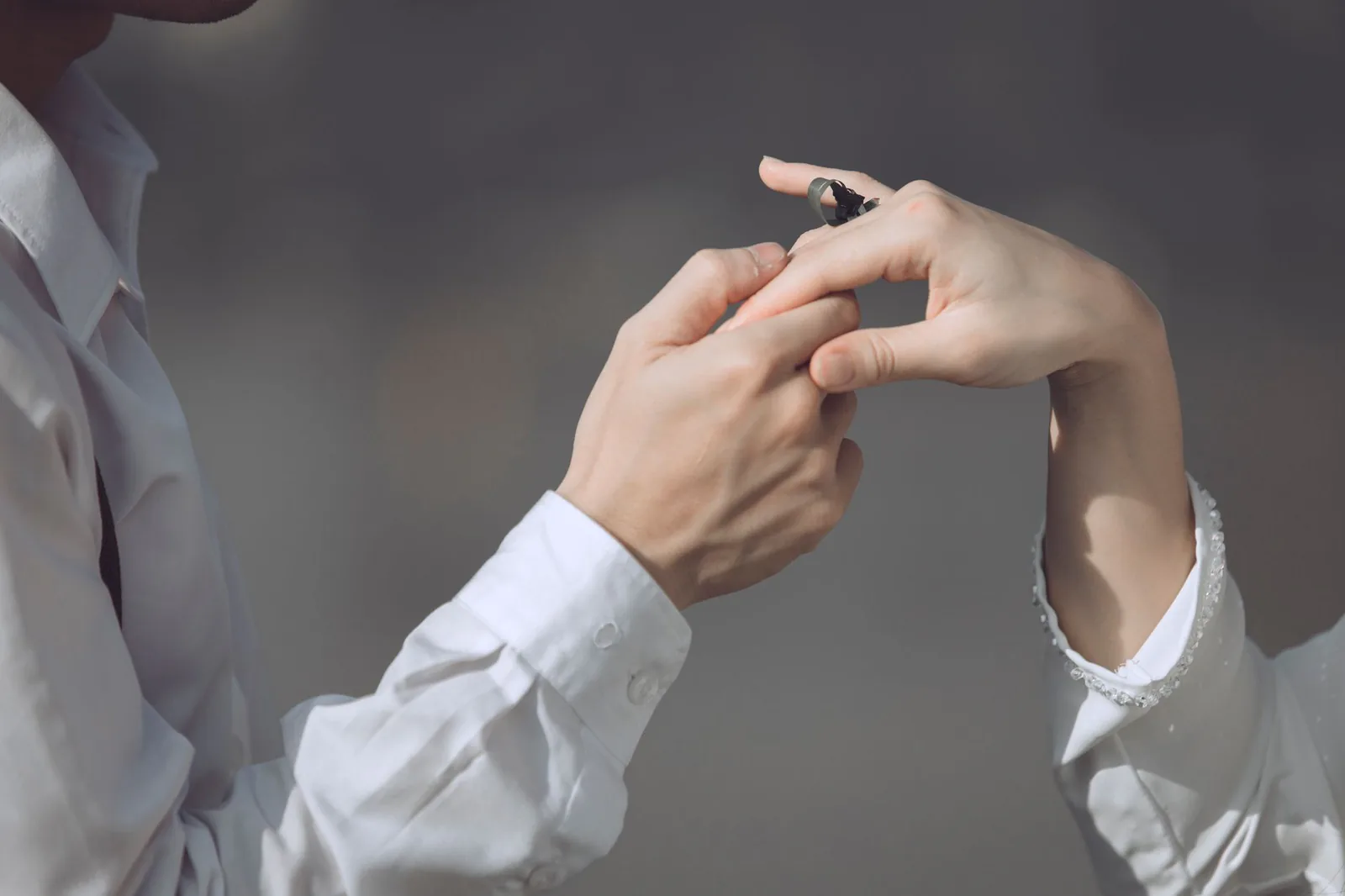 Couple exchanging engagement ring