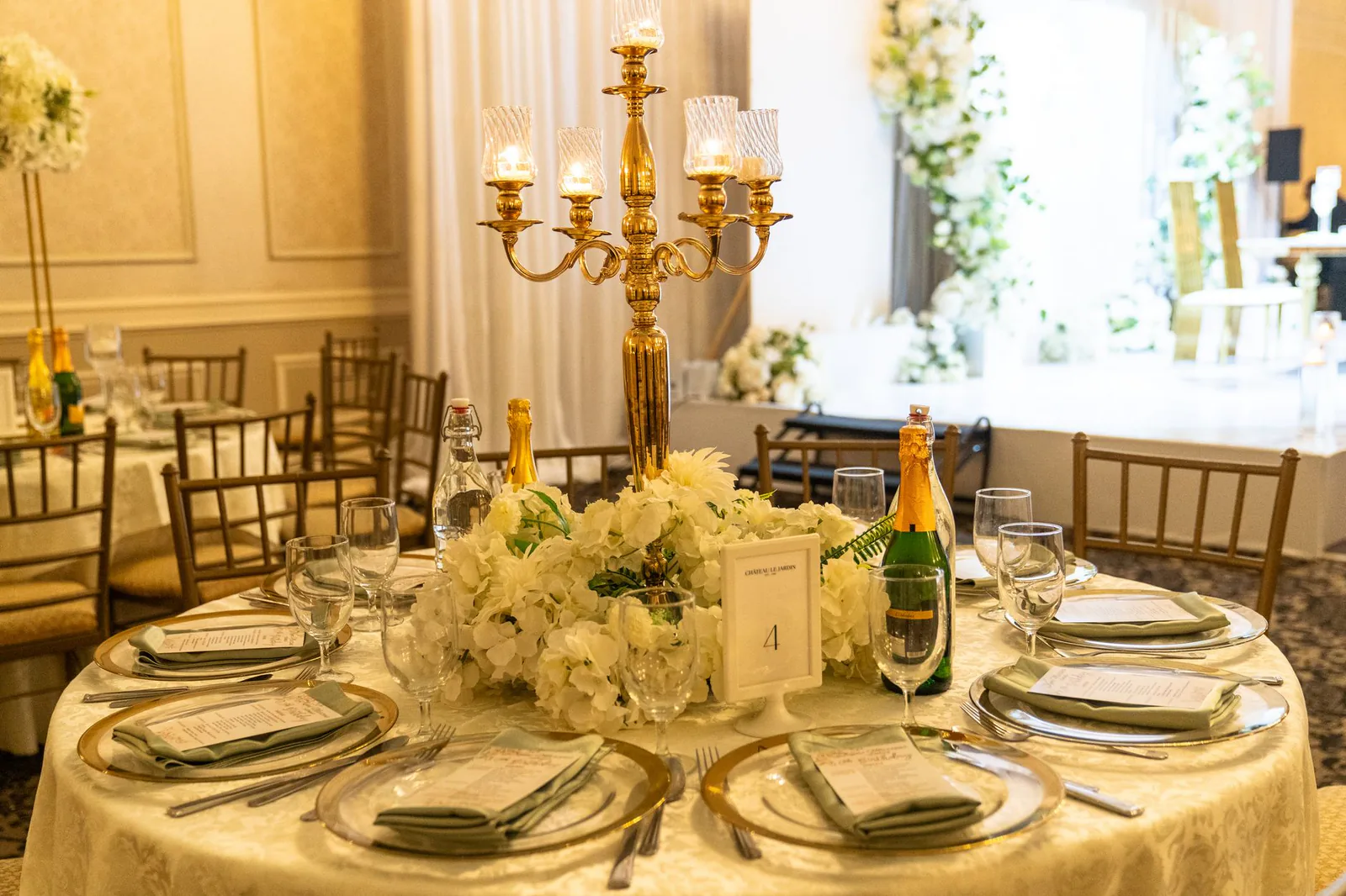Gold candelabra with white floral centerpiece